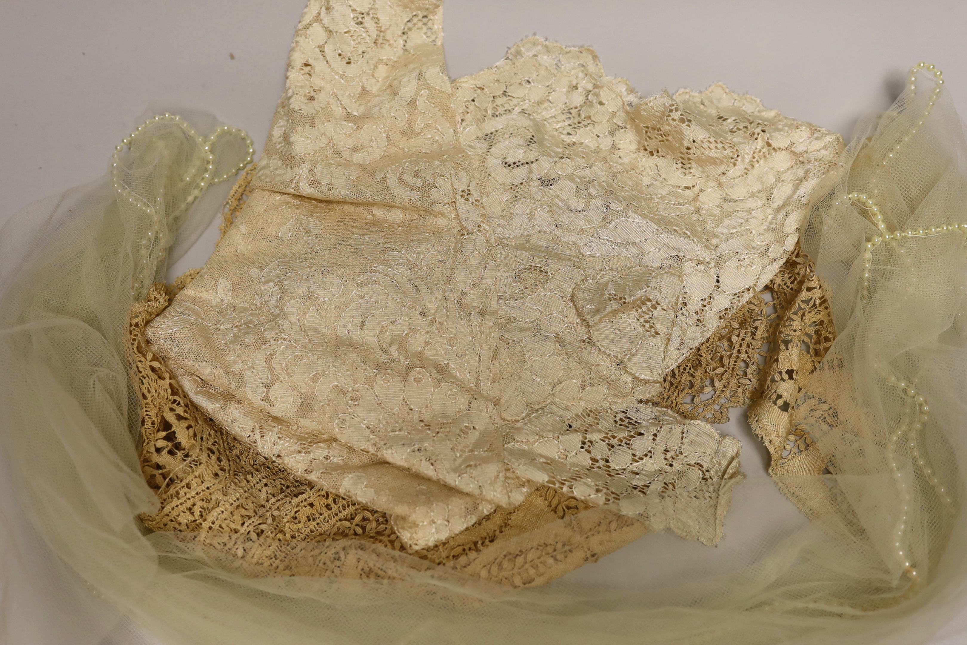 A silk Maltese lace trim, mixed lace and a pearl edged veil